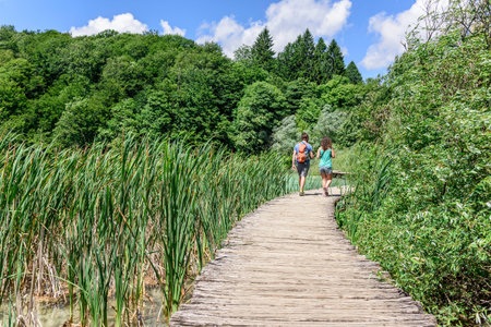 Tourists walking along the wooden walkways in Plitvice Lakes National Park, Croatia.のeditorial素材