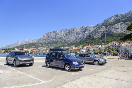 Parking on the waterfront in the resort town of Makarska on a summer day.のeditorial素材
