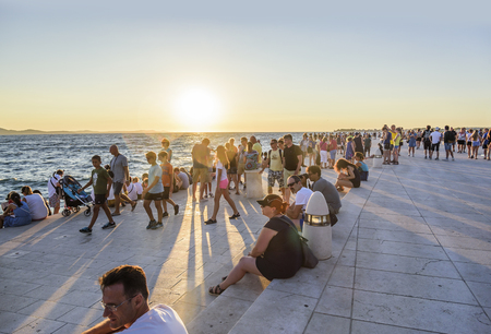 ZADAR, CROATIA - JULY 14, 2017: People listen to the Maritime Authority on the waterfront in Zadar, Croatia. Maritime Authority architectural structure created by architect Nikolai Basic in 2005.のeditorial素材