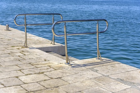 Metal ladder for descent into the sea water.の写真素材