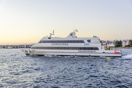 Yacht or small ship goes through the waves in the harbor.のeditorial素材