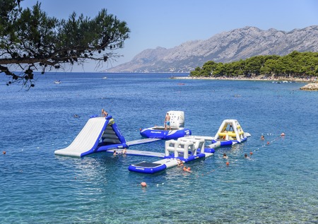 Aquapark on the sea with resting tourists in Brela, Croatia.のeditorial素材