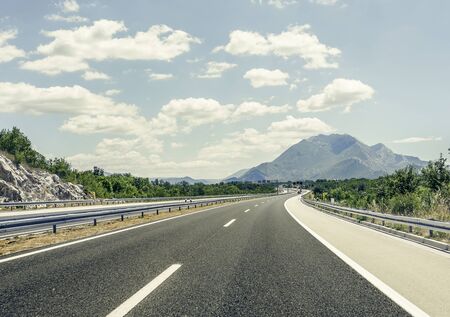 Highway outside the city receding into the highlands.の写真素材