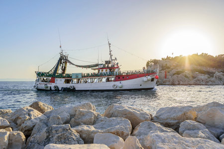 Pleasure boat with cheerful tourists enters the port of Makarska, Croatia.