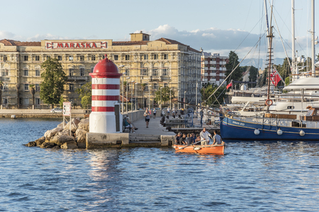 ZADAR, CROATIA - JULY 15, 2017: A small lighthouse tourists on boats and pier in the city of Zadar, Croatia.のeditorial素材