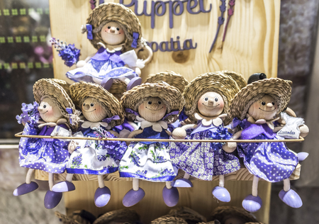 Wooden dolls dressed in purple outfits.のeditorial素材