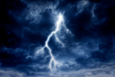 A lightning strike on a cloudy dramatic stormy sky.
