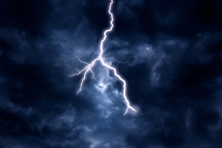 A lightning strike on a cloudy dramatic stormy sky.