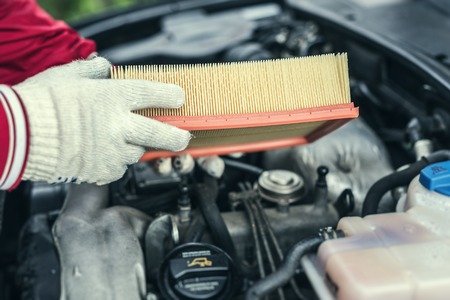 The auto mechanic replaces the cars air filter.の写真素材