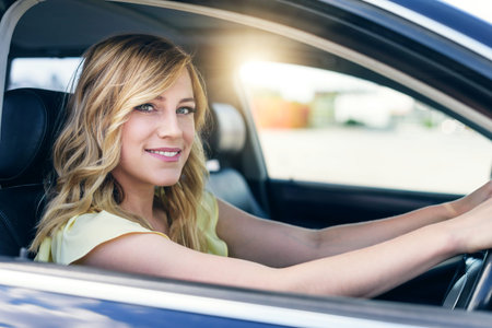 Attractive young woman driving a car.