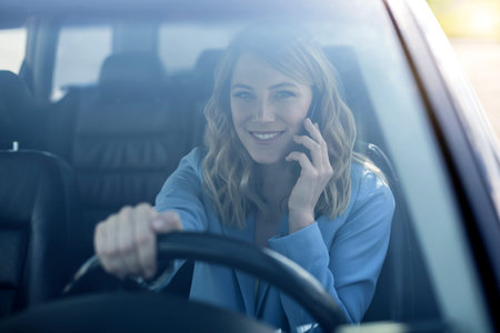 Woman speaks on the phone in the car.