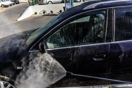 High-pressure washing car outdoors. Car Audi A6 in a high pressure washer.のeditorial素材