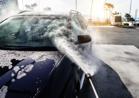 High-pressure washing car. Car washing under the open sky.の写真素材