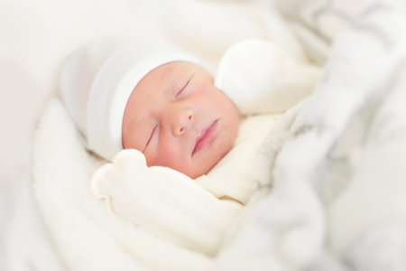 Sleepy baby close-up in a baby cot.
