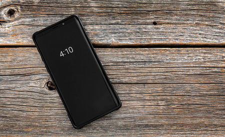 Smartphone on wooden background.