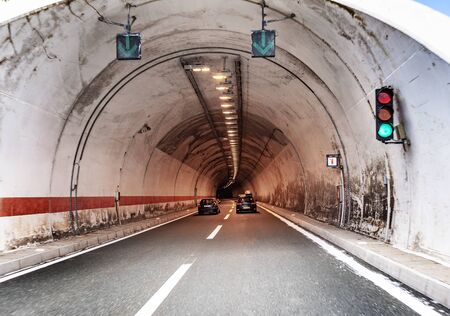 Cars move in a tunnel through a mountain on a freeway.のeditorial素材