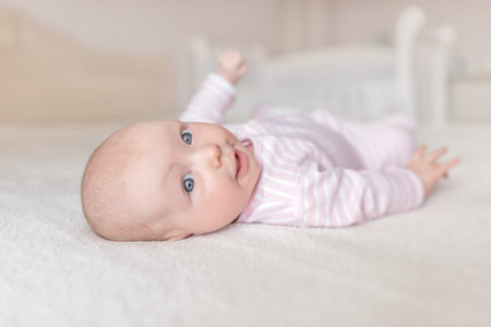 Little baby in a white crib.