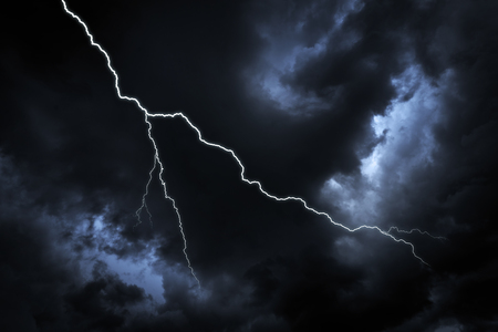 Lightning strike on the dark cloudy sky.の写真素材