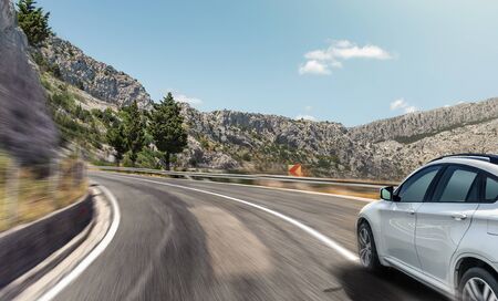 White car rushing along a high-speed highway.の写真素材