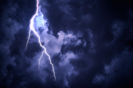 Lightning strike on a cloudy dark sky.