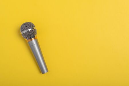 Concert microphone on beautiful yellow background.の写真素材