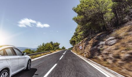 Car rushes along the road to the sea.の写真素材