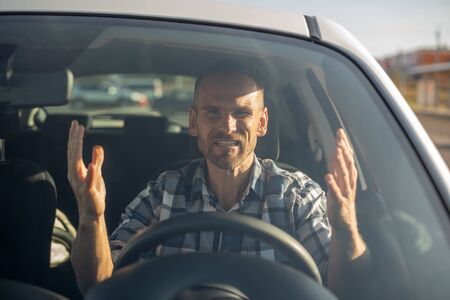 Angry driver drives a car in the city.の写真素材