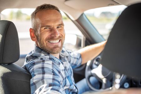 Attractive man driving a car.の写真素材