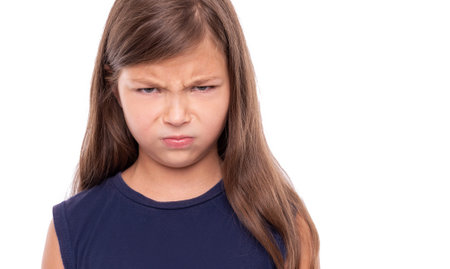 Angry baby girl on white background.
