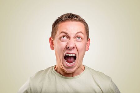 An angry young man screams.の写真素材