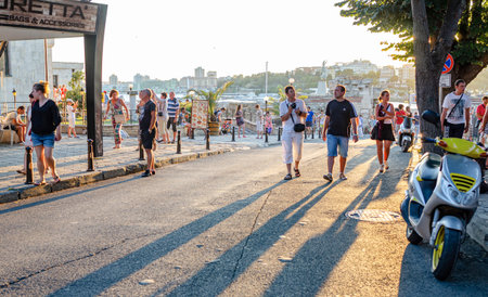 Many tourists in the rays of the evening sun in Nessebar, Bulgaria.