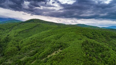 Spring landscape in mountains and the dark blue sky with clouds.の写真素材