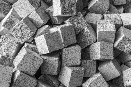 Gray stone paving stones as background. A pile of stone cubes as an abstract background.の写真素材