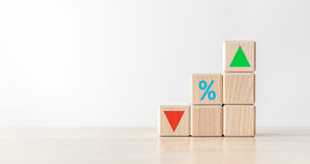 Wooden cube blocks with sign percentage symbol and arrow indicating up and down direction.