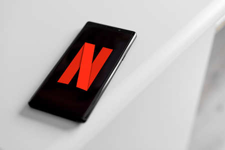 Netflix company logo on the smartphone screen.のeditorial素材