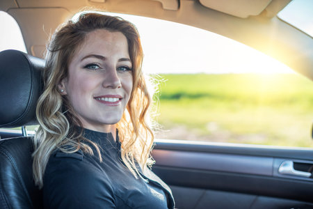 Blonde in the car. Attractive woman drives a car.