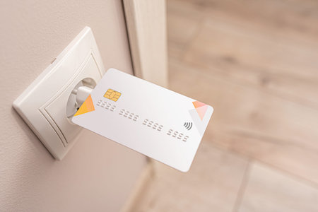 The bank credit card is charged from an electrical outlet.