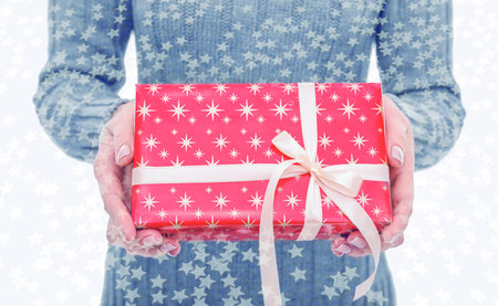 Gift in hands on a festive background.