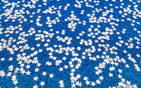 Scattered stars on a blue festive background.
