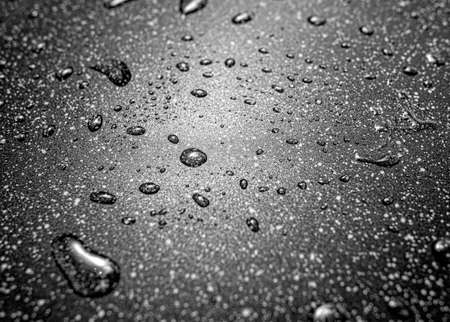 Water drops on a granite slab.の写真素材