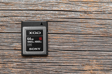 Sony XQD memory card on a wooden background.