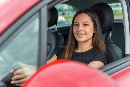 Beautiful young woman driving a car.