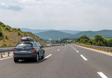 A Skoda Kodiaq with a roof rack and other cars drive along the highway in Plitvice, Croatia.のeditorial素材