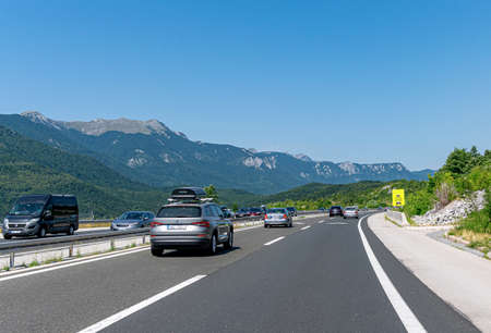 A Skoda Kodiaq with a roof rack and other cars drive along the highway in Plitvice, Croatia.のeditorial素材