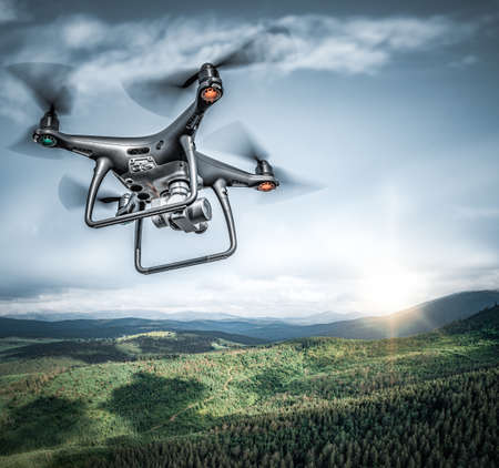 Dark drone flying above mountains.の写真素材