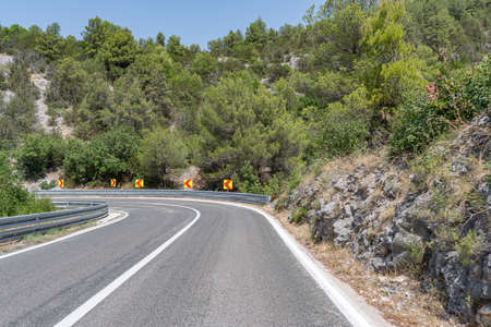 A road with sharp turns in the mountains.の写真素材