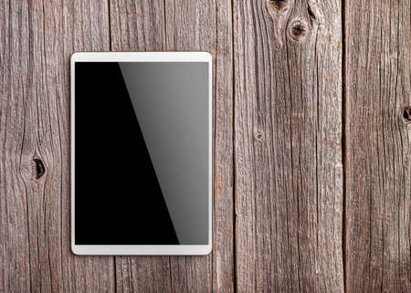 White digital tablet on wooden tableの写真素材