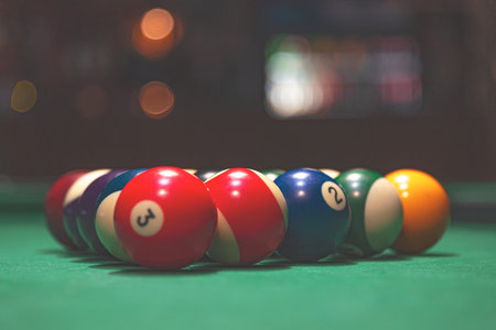 Billiard balls in a green billiard table.