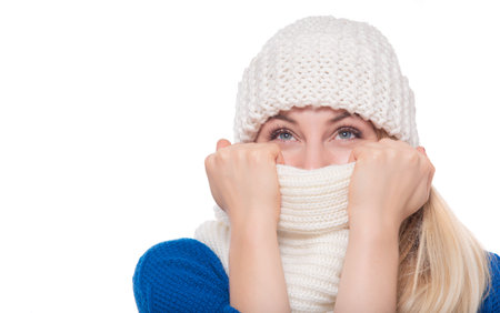 Joyful woman in winter clothes on a white background.