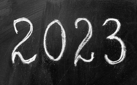 The inscription 2023 in chalk on a blackboard.の写真素材